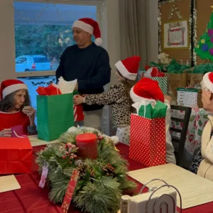 Forest Cottage Senior Care Christmas Party Passing Gifts to Residents