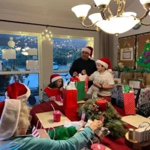 Forest Cottage Senior Caree Christmas Party Passing Out Gifts To Residents